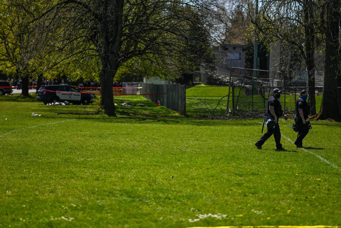 Portland police officers patrol the scene of a police shooting in Lents Park.