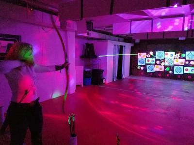 Once a Month, You Can Shoot a Bow and Arrow Under Black Lights in Tigard
